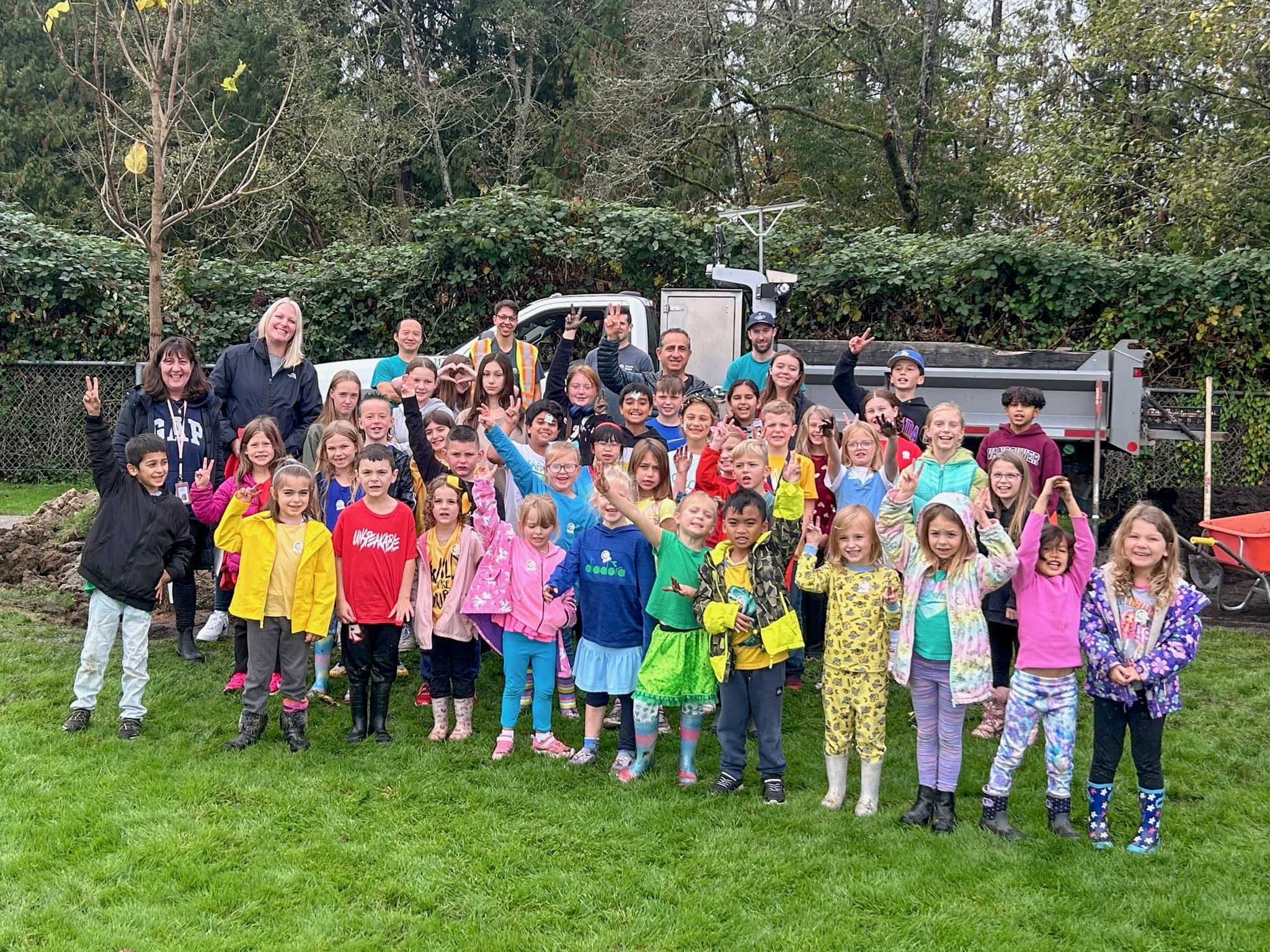 Alexander Robinson Elementary students who participated in the tree planting drive take a group photo.