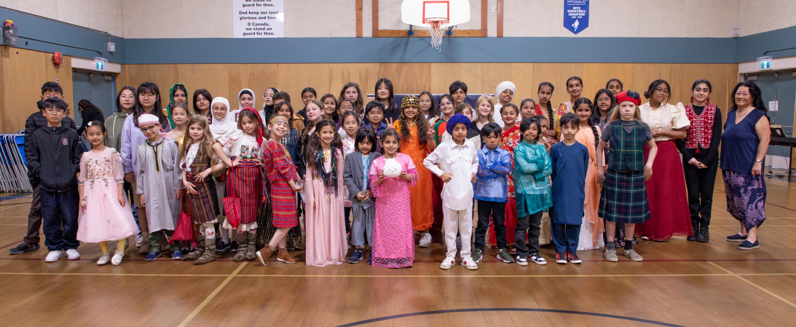 Students who took part in Highland Park Elementary's World Culture Day assembly pose for a group photo in the gymnasium.