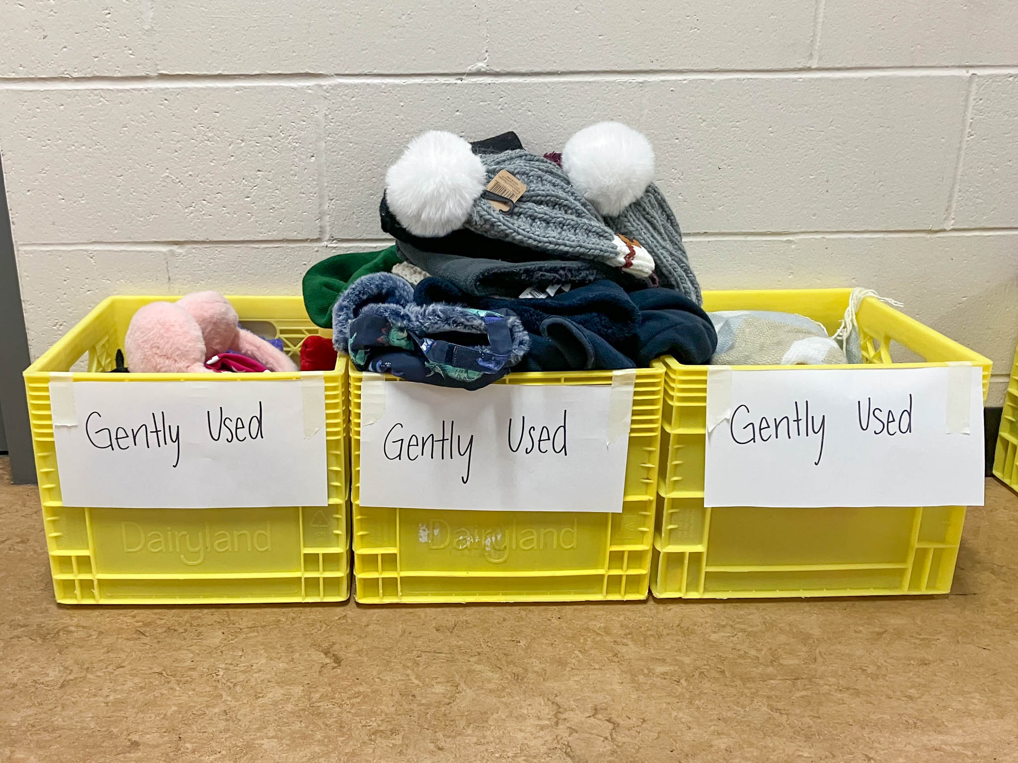 Three crates full of gently used toques, gloves and scarves for donation at Davie Jones Elementary.