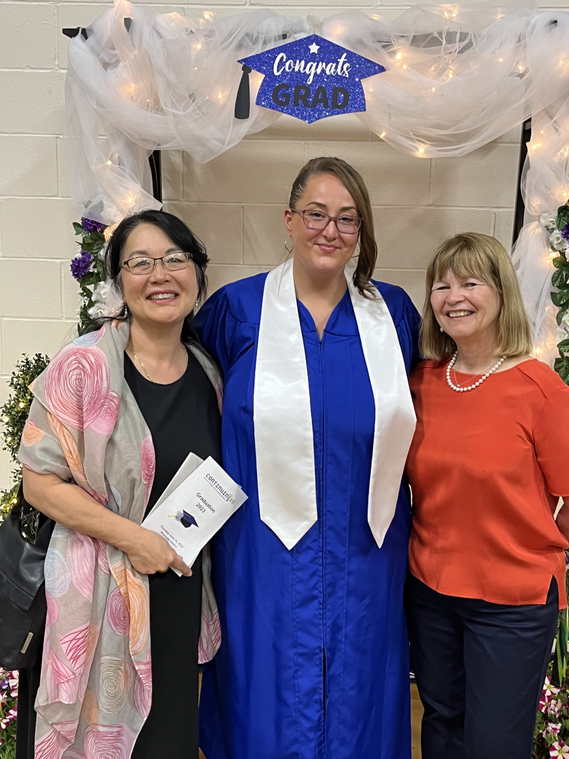 Continuing Education class of 2023 valedictorian Channi Gonzales with instructor Kim Henneberry Glover and school board chairperson Elaine Yamamoto.