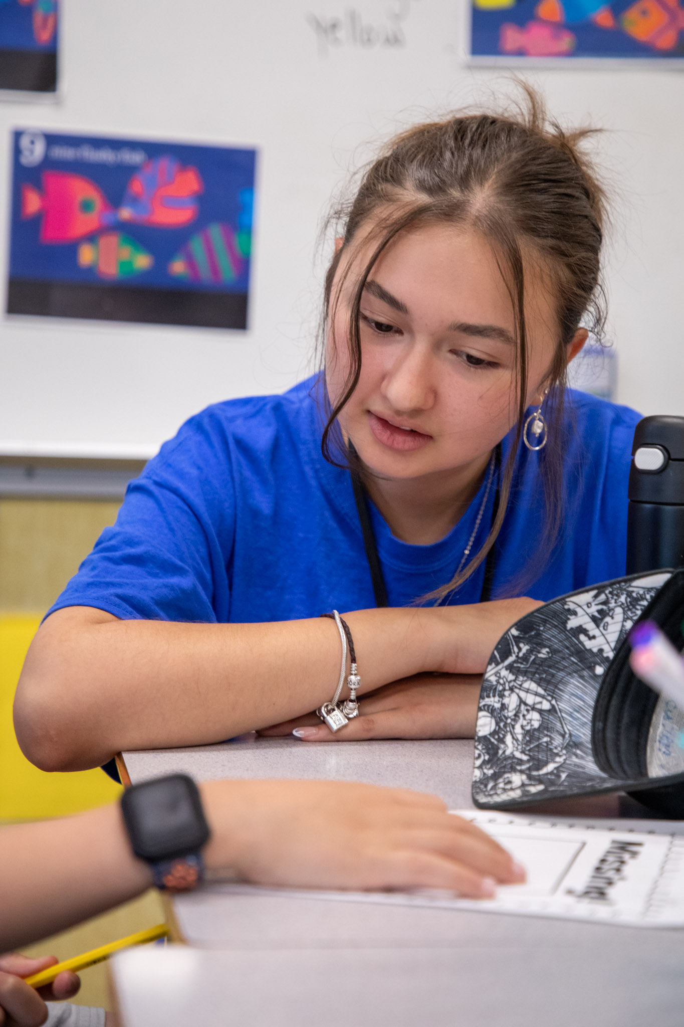 Summer learning volunteer Maya Mendez-Whitehead works with a student on an assignment.